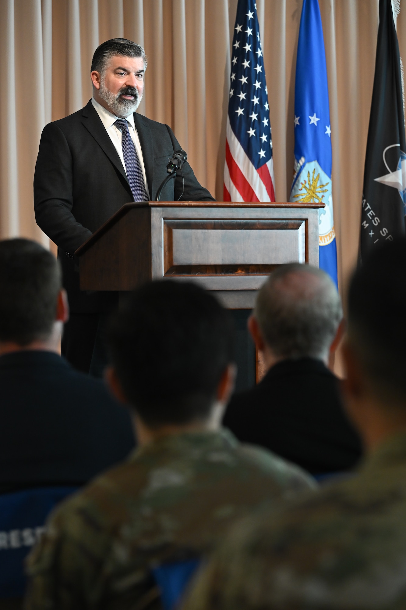 William D. Bailey, preforming the duties of the Assistant Secretary of the Air Force for Acquisition, Technology and Logistics, speaks to Department of the Air Force Portfolio Acquisition Executive for Command, Control, Communications and Battle Management personnel and guests during a change of leadership ceremony, here, Aug. 28. Brig. Gen. Joshua Williams officially assumed leadership of DAF PAE C3BM on July. 31, 2026. (Official Air Force Photo by Richard Blumenstein).