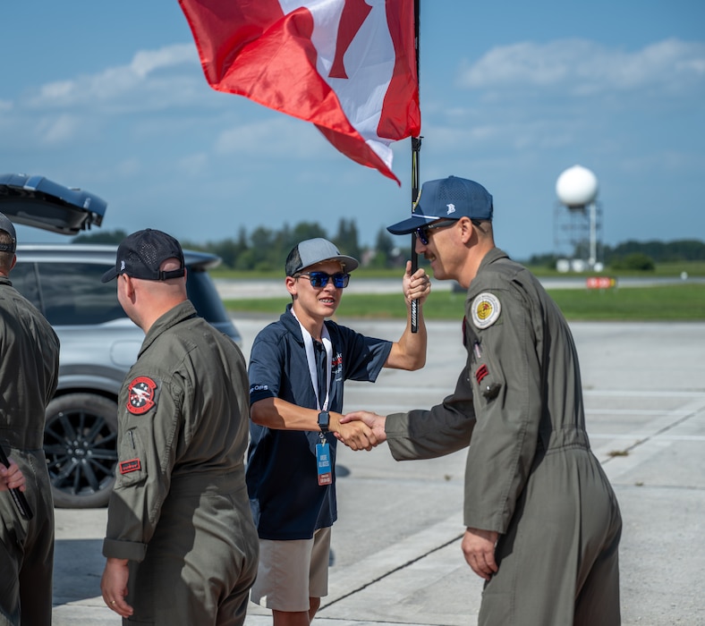 U.S. Air Force Master Sgt. Alex Esquibel, 54th Air Refueling Squadron KC-135 formal training unit evaluator boom operator, shakes an Airshow London 2026 volunteer’s hand in London, Ontario, Aug. 20, 2026. While the combined Altus Air Force Base demonstration team was not performing, they had the opportunity to engage with attendees. (U.S. Air Force photo by Airman 1st Class Emma Wright)