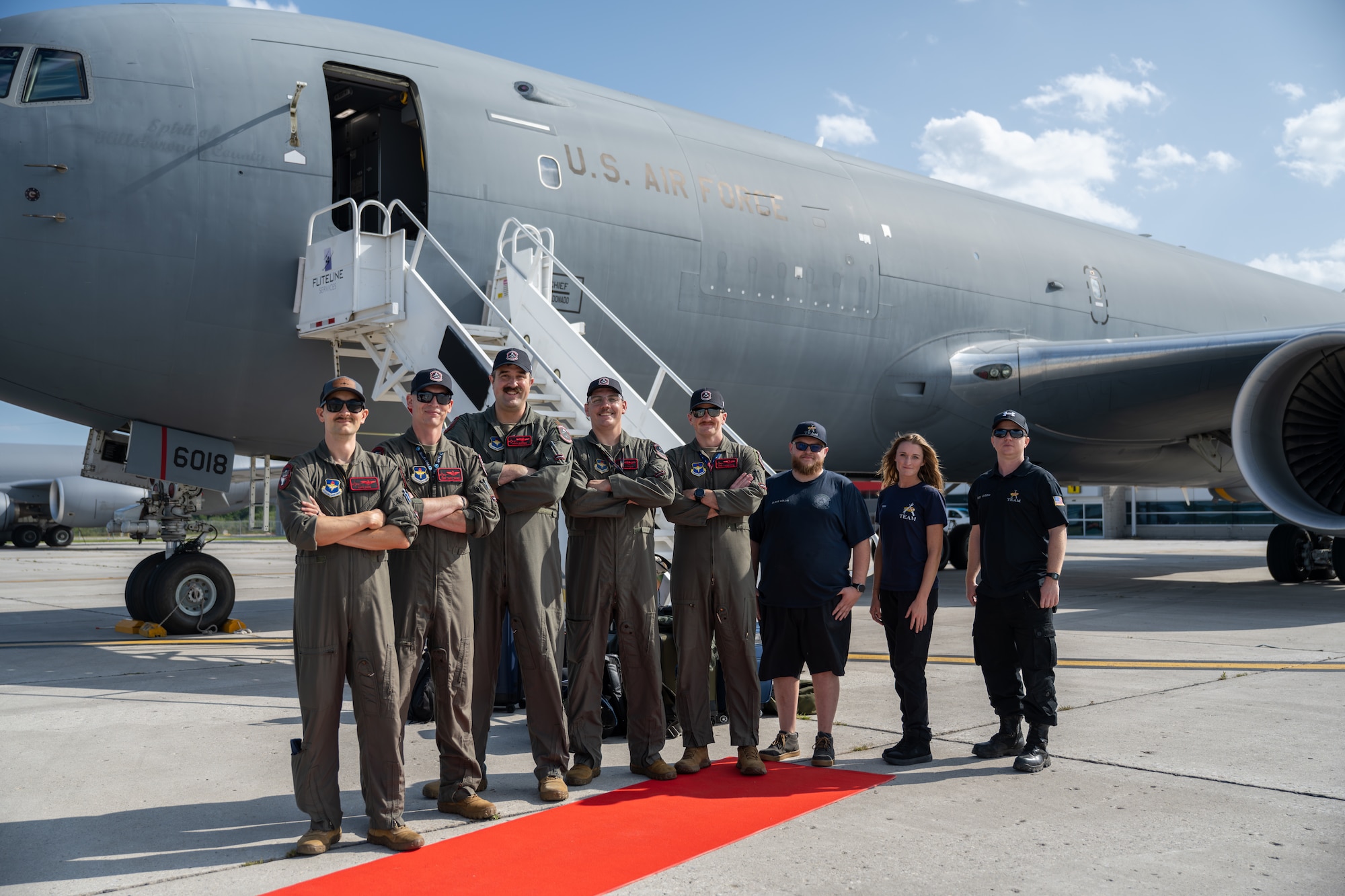 The Altus Air Force Base KC-46 Pegasus demonstration team smiles in front of the U.S. Air Force KC-46 Pegasus aircraft in London, Ontario, Aug. 20, 2026. The KC-46 is a modern aerial tanker that refuels military aircraft while in flight. (U.S. Air Force photo by Airman 1st Class Emma Wright)