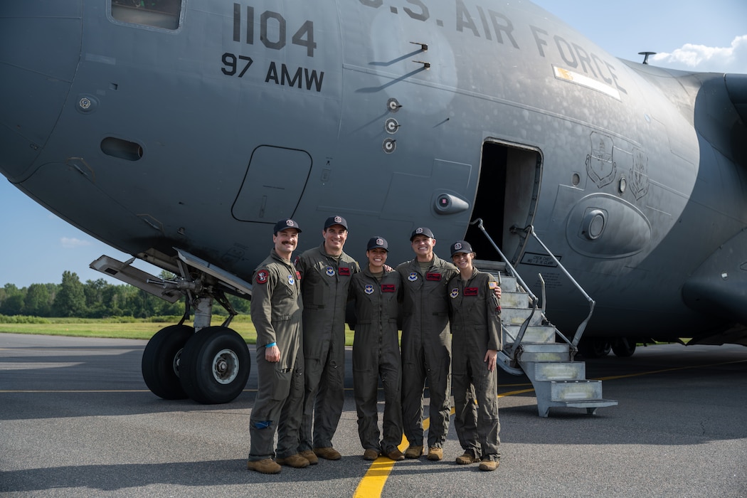 The Altus Air Force Base C-17 Globemaster III demonstration team smiles in front of the U.S. Air Force C-17 Globemaster III aircraft in London, Ontario, Aug. 20, 2026. The C-17 demonstration team consisted of three instructor pilots and two evaluator loadmasters. (U.S. Air Force photo by Airman 1st Class Emma Wright)