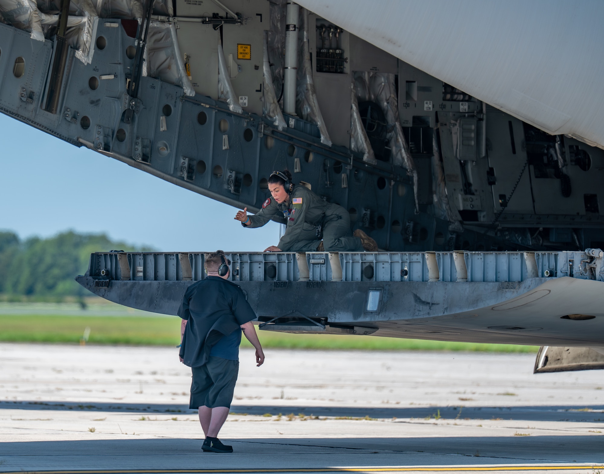 U.S. Air Force Tech. Sgt. Aleea Barreras, 58th Airlift Squadron C-17 formal training unit instructor evaluator loadmaster, speaks to Dillon Feazel, 97th Maintenance Group C-17 maintainer, London, Ontario, Aug. 21, 2026. Loadmasters, pilots, and 97th MXG crew worked as a team throughout the airshow. (U.S. Air Force photo by Airman 1st Class Emma Wright)