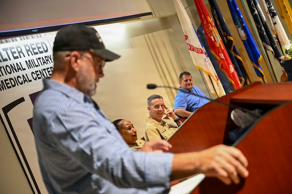 Senior Chief Hospital Corpsman Christopher Johnson (Retired) speaks as the guest speaker at Senior Chief Hospital Corpsman Thomas Riggs retirement ceremony at Walter Reed National Military Medical Center, August 20, 2026. Navy Medicine Readiness and Training Command (NMRTC) Bethesda mission is to maximize warfighter performance through optimized medical readiness tailored to operational requirements; enhance the readiness of the medical force to sustain expeditionary medical capability; and train and develop the Navy Medicine Force. (U.S. Navy photo Mass Communication Specialist Second Class Alec Kramer)