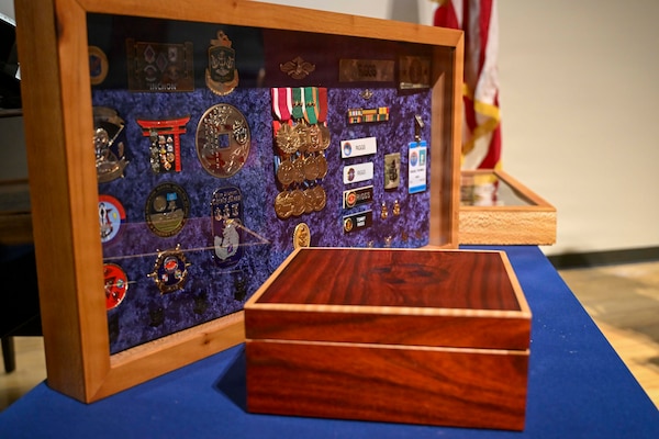 The “Shadow Box” presented to Senior Chief Hospital Corpsman Thomas Riggs, assigned to Navy Medicine Readiness and Training Command (NMRTC) Bethesda, during his retirement ceremony at Walter Reed National Military Medical Center, August 20, 2026. The Navy “Shadow Box” is a long-standing naval tradition honoring a Sailor’s career and service. NMRTC Bethesda mission is to maximize warfighter performance through optimized medical readiness tailored to operational requirements; enhance the readiness of the medical force to sustain expeditionary medical capability; and train and develop the Navy Medicine Force. (U.S. Navy photo Mass Communication Specialist Second Class Alec Kramer)