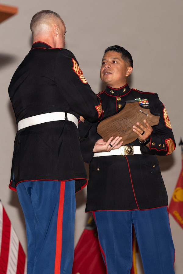 U.S. Marine corps Master Sgt. Luis Parreno, right, Marine Corps Recruiting Command liaison with School of Infantry West, receives a plaque during a Marine Corps Recruiting and Retention School class 5-26 graduation ceremony at Marine Corps Recruit Depot San Diego, California, Aug. 11, 2026. The ceremony recognized Marines who successfully completed MCRRS and earned the military occupational specialty of Marine Corps recruiter or career counselor, equipping them to represent the Marine Corps and mentor Marines across the force. (U.S. Marine Corps photo by Lance Cpl. Siwan Lewis)