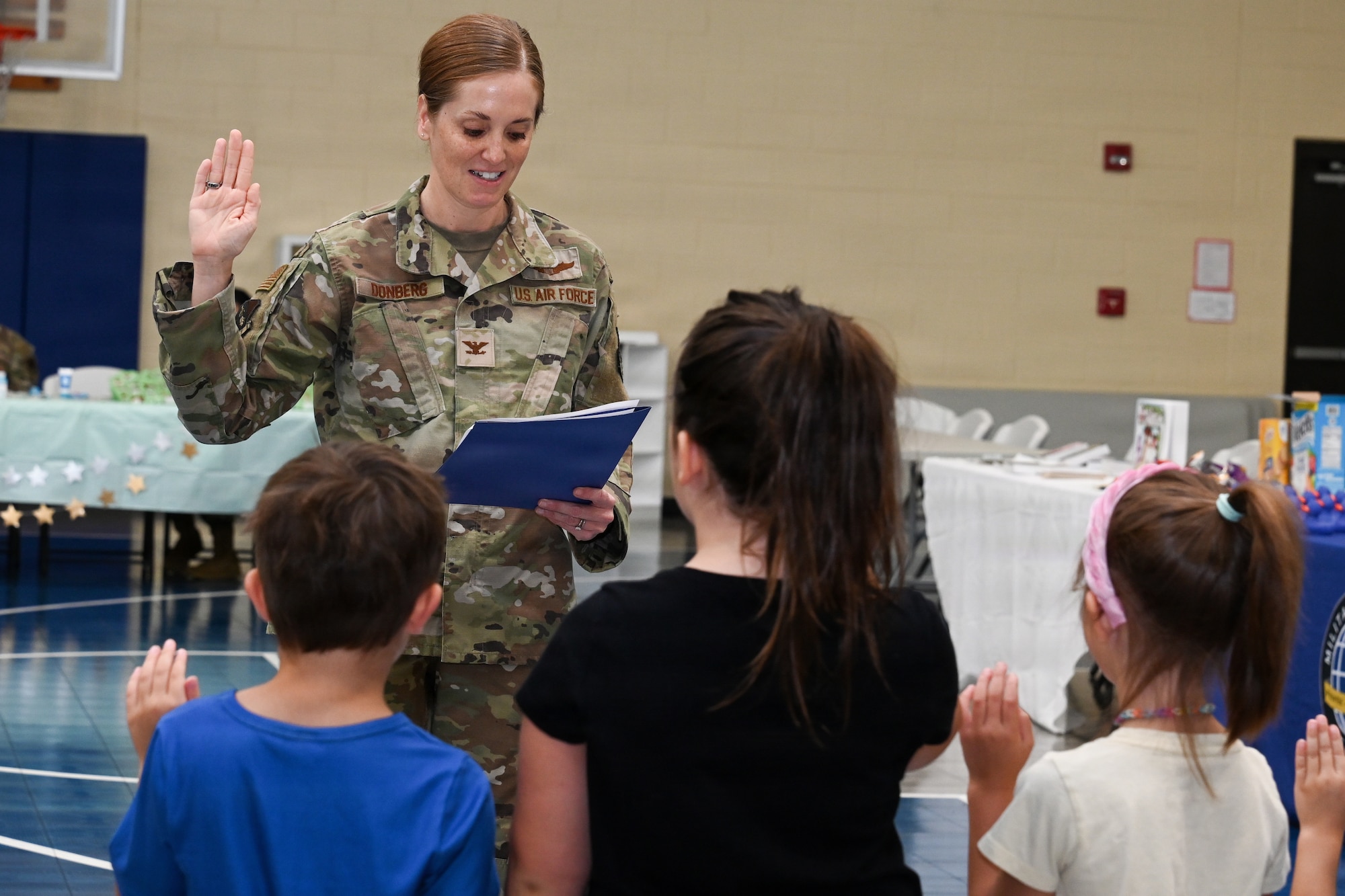 Military children doing a oath of enlistment for a mock deployment.