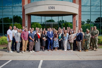 Staff and service members pose for a photo during the Navy Operational Medicine Information Technology & Fielding Summit in Chesapeake, Virginia, Aug. 24, 2026. The five-day summit, held at the CACI Building in Chesapeake, brings together senior leaders from BUMED, Fleet commands, Naval Information Warfare Centers, and Joint Operational Medicine Information Systems teams. The primary objective was to deliver agile, trained, and certified medical units to support the Fleet, Fleet Marine Force and expeditionary medical facilities. (U.S. Navy photo by Mass Communication Specialist 2nd Class Levi Decker)