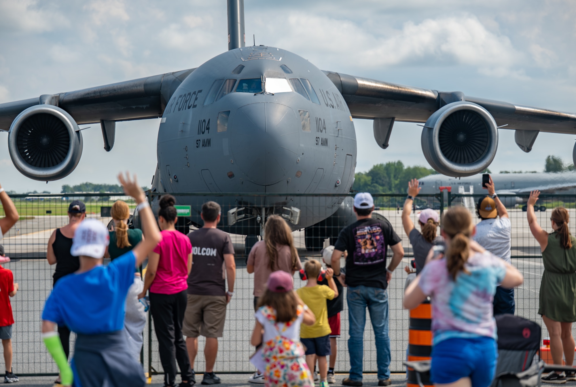Spectators of Airshow London 2026 take photos and wave to the Altus C-17 demonstration team aboard the U.S. Air Force C-17 Globemaster III, London, Ontario, Aug. 22, 2026. The C-17 can transport more than 170,000 pounds of cargo and operate from relatively short runways. (U.S. Air Force photo by Airman 1st Class Emma Wright)