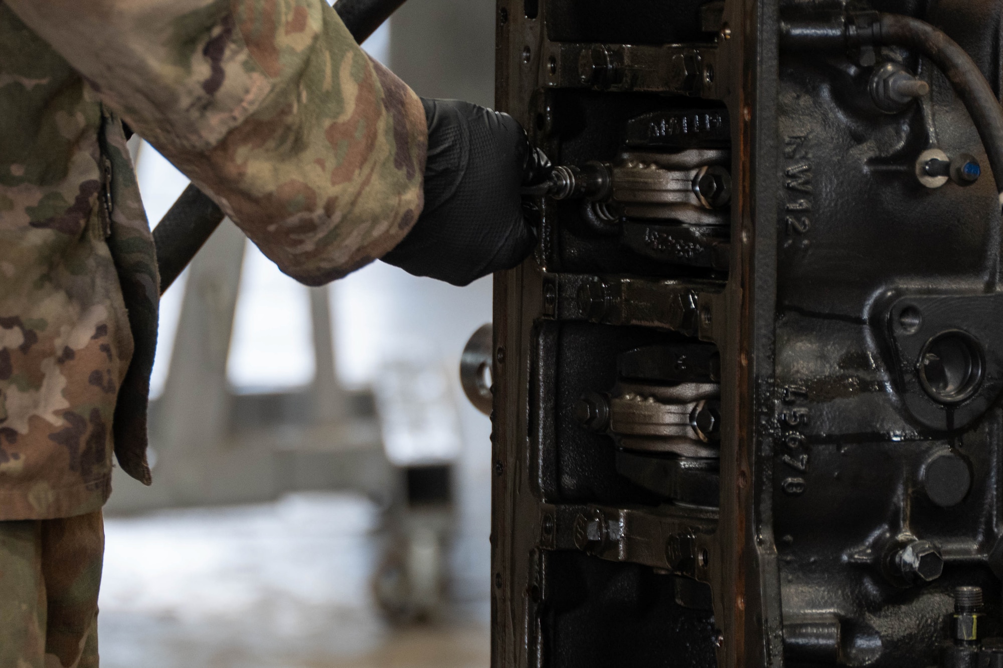 An Airman of the 185th Civil Engineering Squadron, Iowa National Guard, works on an engine of a 60-kilowatt generator