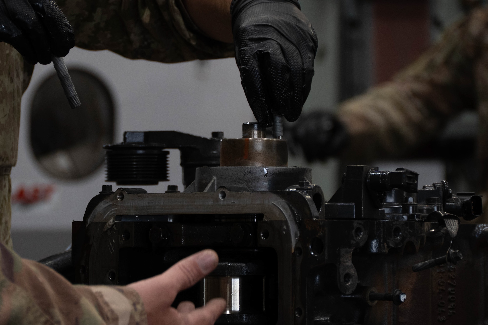 An Airman of the 185th Civil Engineering Squadron, Iowa National Guard, works on an engine of a 60-kilowatt generator