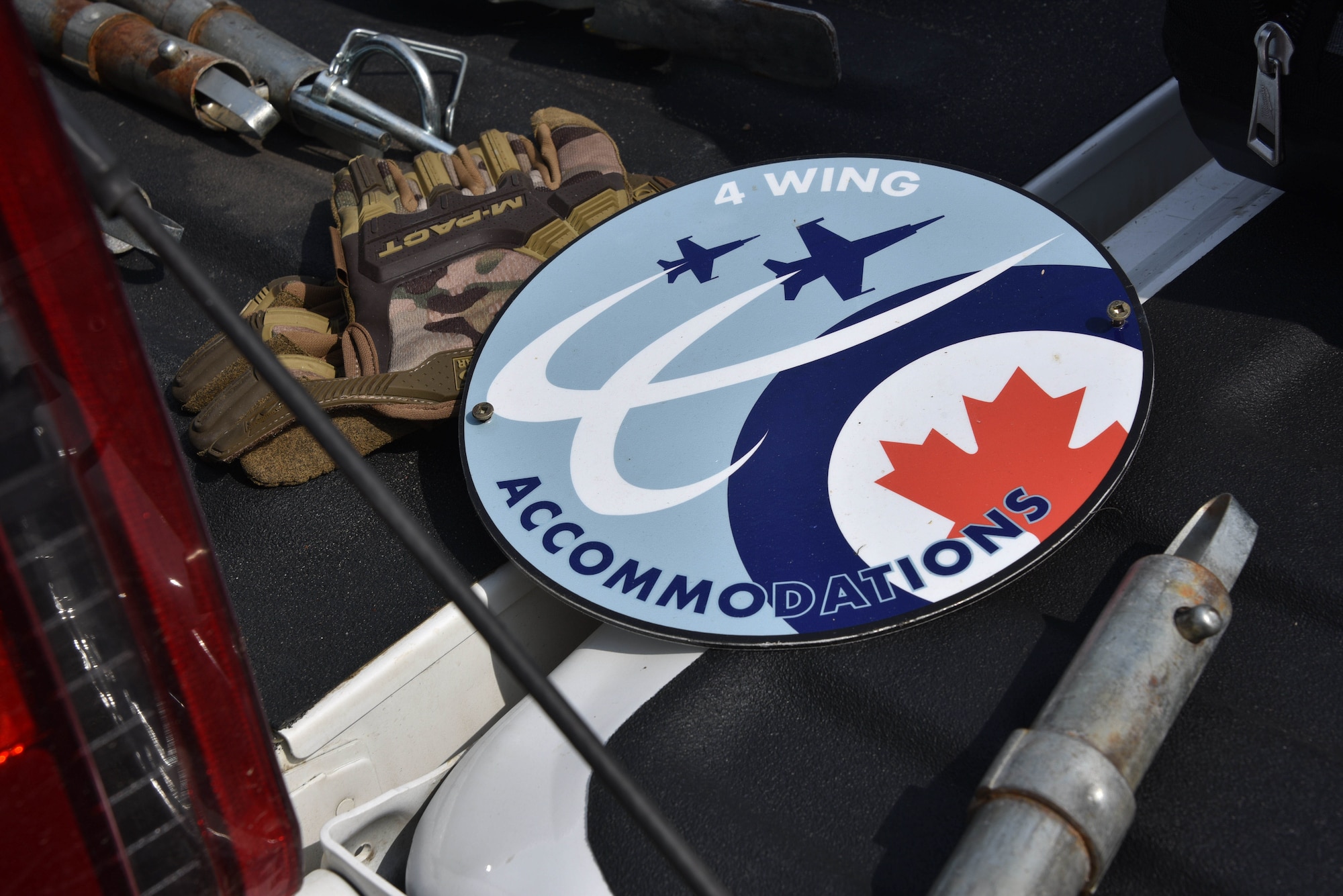 A 4-Wing residential housing unit sign of the Royal Canadian Armed Forces lays in the back of a vehicle bed