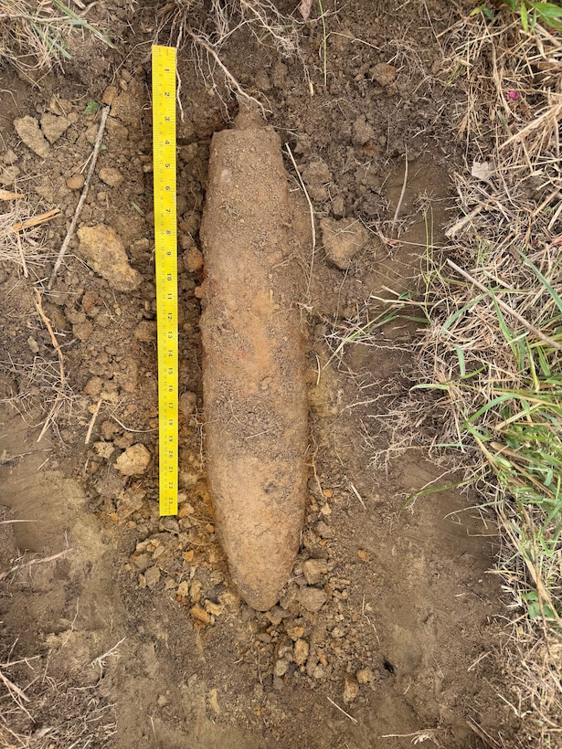 An ordnance lays on the ground.