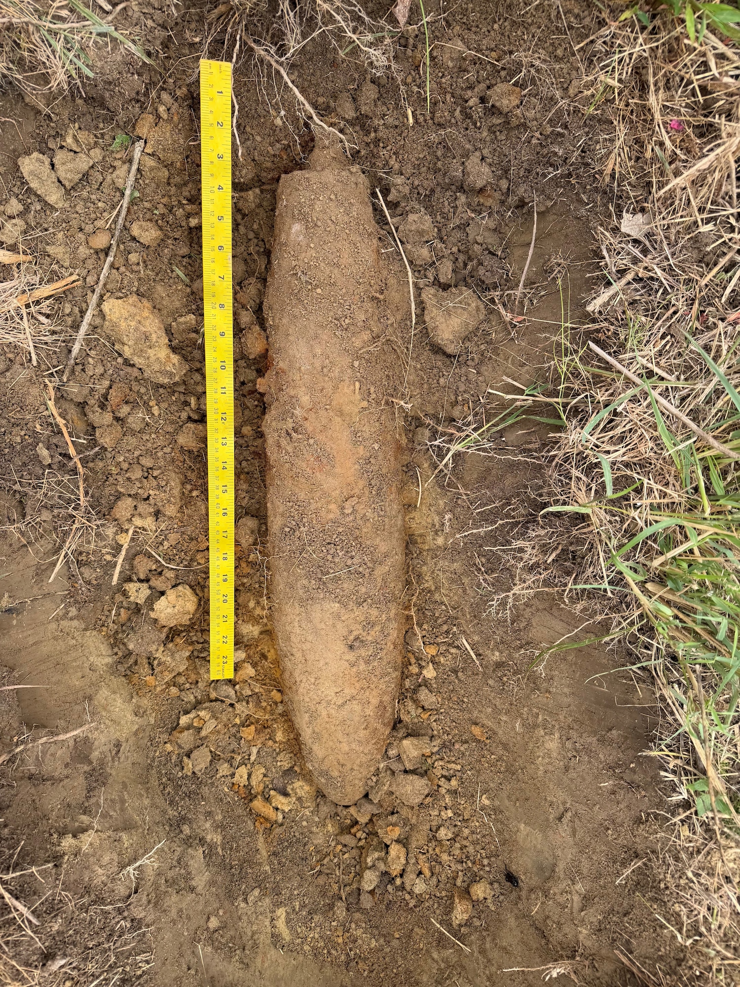 An ordnance lays on the ground.