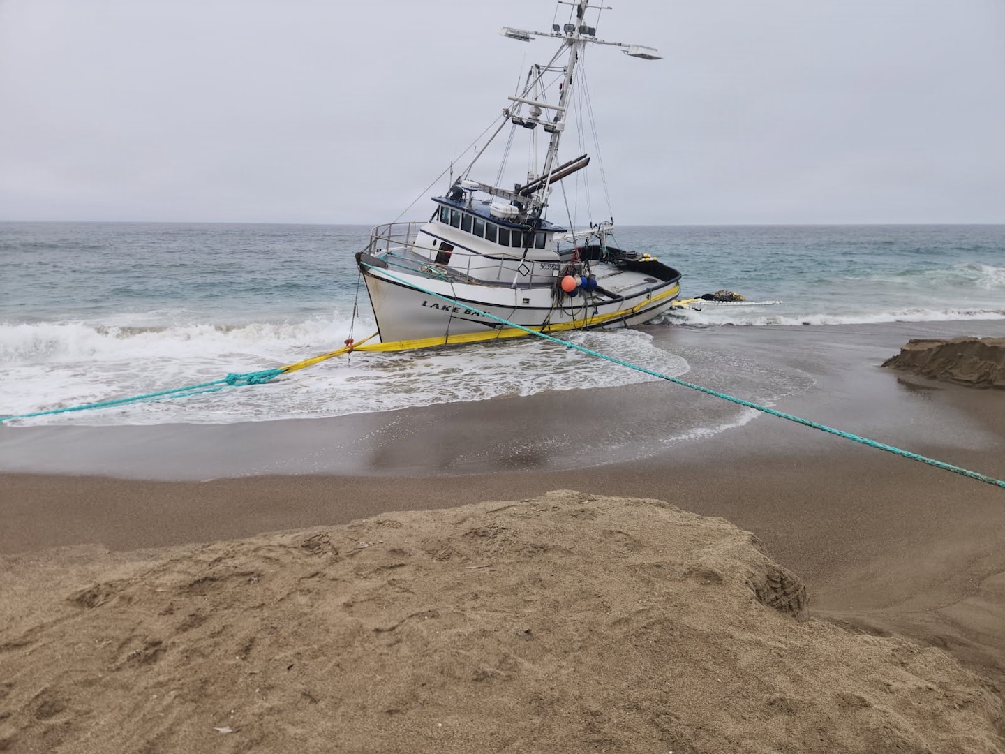 Aground fishing vessel Lake Bay rests on Point Reyes North Beach, California, August 27, 2026. After response crews from the Coast Guard, National Parks Service, California Fish and Wildlife, and Parker Diving removed all fuel and petroleum from the vessel, crews rigged the vessel’s hull with stabilization straps and tow lines for shore-
based removal. (U.S. Coast Guard courtesy photo)