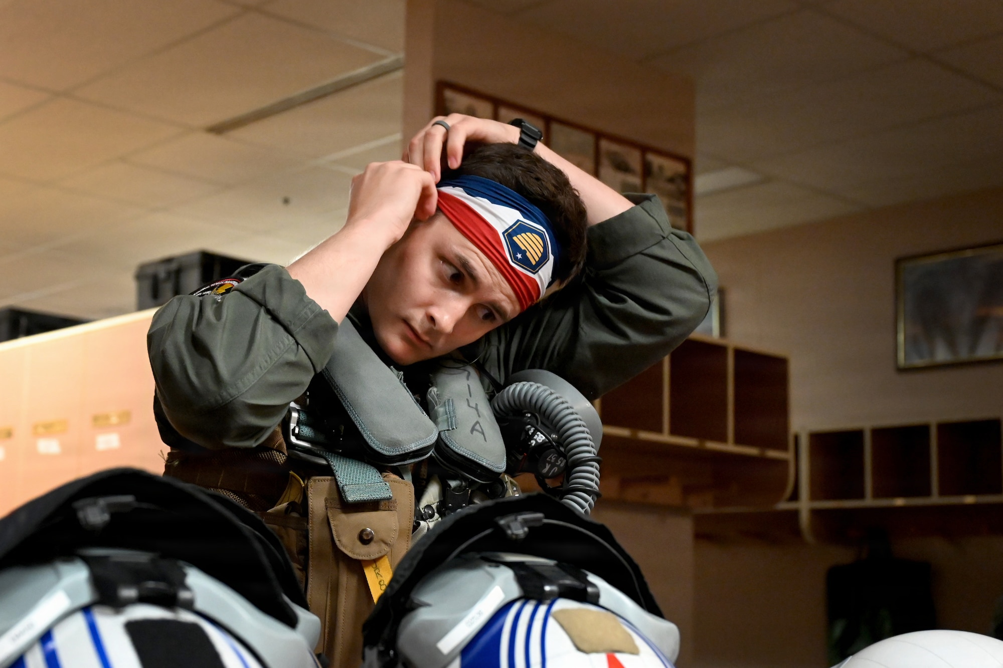 U.S. Navy Lt. Jake Rotzler, Electronic Attack Squadron 134 EA-18G Growler pilot, dons flight equipment during RED FLAG-Alaska 26-3 at Eielson Air Force Base, Alaska, Aug. 25, 2026.