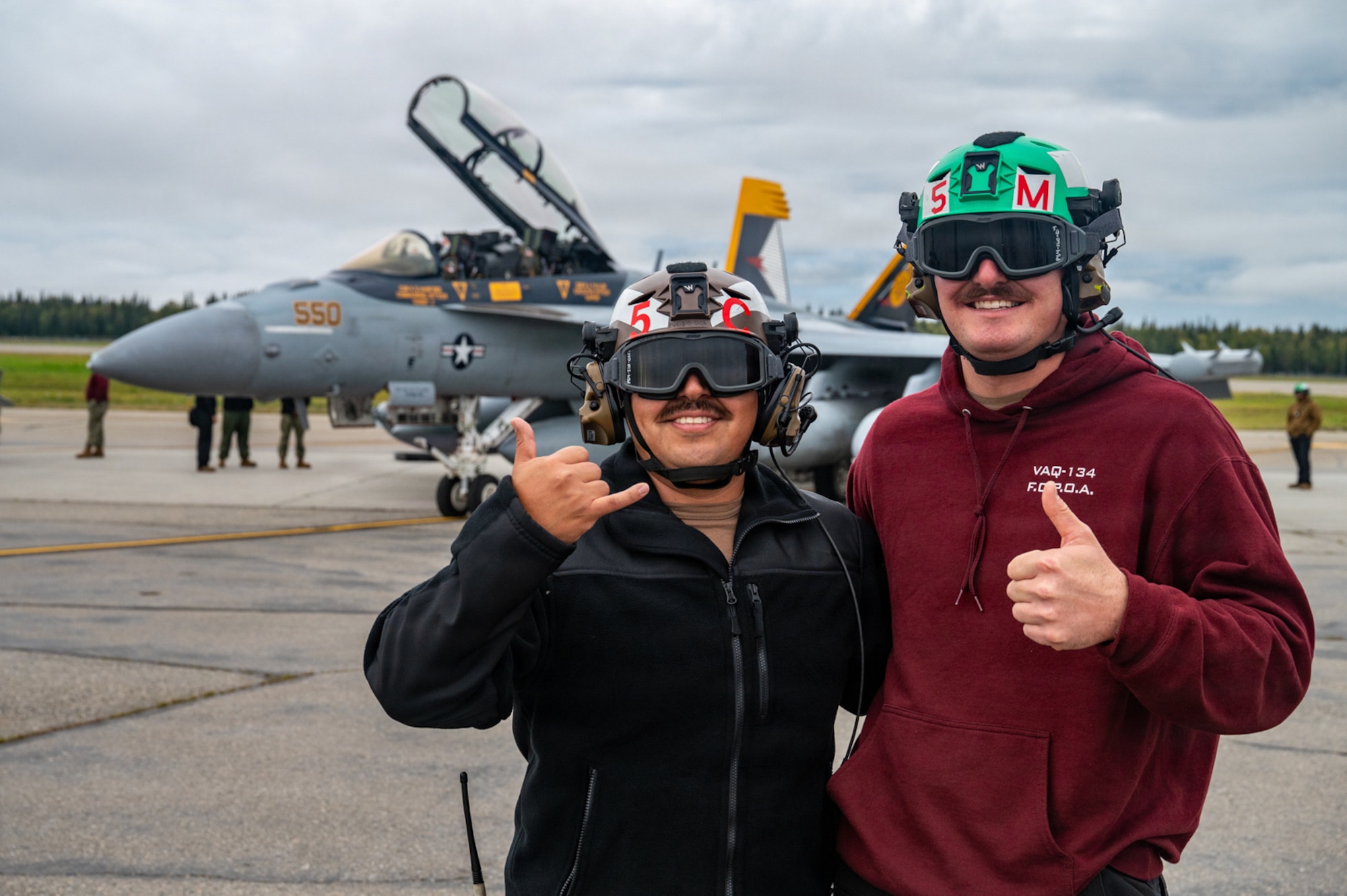 U.S. Navy Chief Petty Officer Robert Ramos, Electronic Attack Squadron 134 line leading chief petty officer, left, and Petty Officer 1st Class Tyler Bretsch, VAQ-134 airframes supervisor, pose for a photo during RED FLAG-Alaska 26-3 at Eielson Air Force Base, Alaska, Aug. 20, 2026.