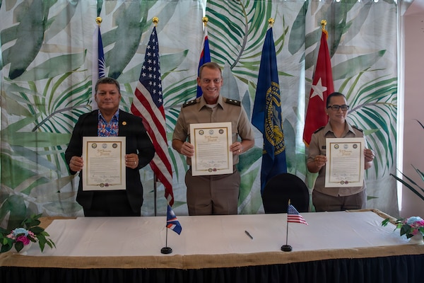 From left, Chris Debrum, director of the Republic of the Marshall Islands Office of National Security; Maj. Gen. Craig Strong, adjutant general of the Nebraska National Guard; and Brig. Gen. Karin Watson, adjutant general of the Guam National Guard, display the newly signed Department of War National Guard Bureau State Partnership Program agreements in Majuro, Republic of the Marshall Islands, Aug. 25, 2026.