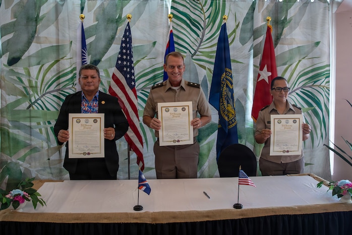 From left, Chris Debrum, director of the Republic of the Marshall Islands Office of National Security; Maj. Gen. Craig Strong, adjutant general of the Nebraska National Guard; and Brig. Gen. Karin Watson, adjutant general of the Guam National Guard, display the newly signed Department of War National Guard Bureau State Partnership Program agreements in Majuro, Republic of the Marshall Islands, Aug. 25, 2026.