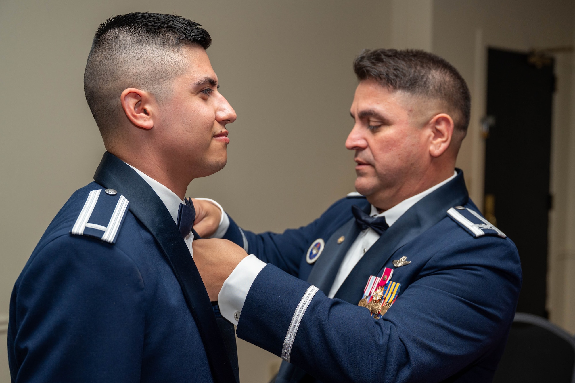 1st Lt. Steven Torres, 47th Student Squadron student pilot, receives his silver wings with assistance from his guest.