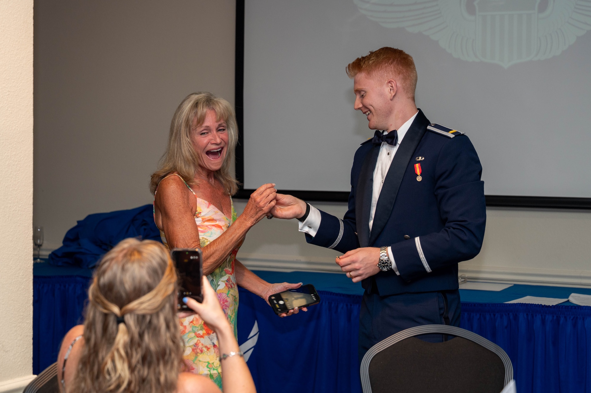 2nd Lt. Scott Rockett, 47th Student Squadron student pilot, gives his loved one half of his broken silver wings from his guest.