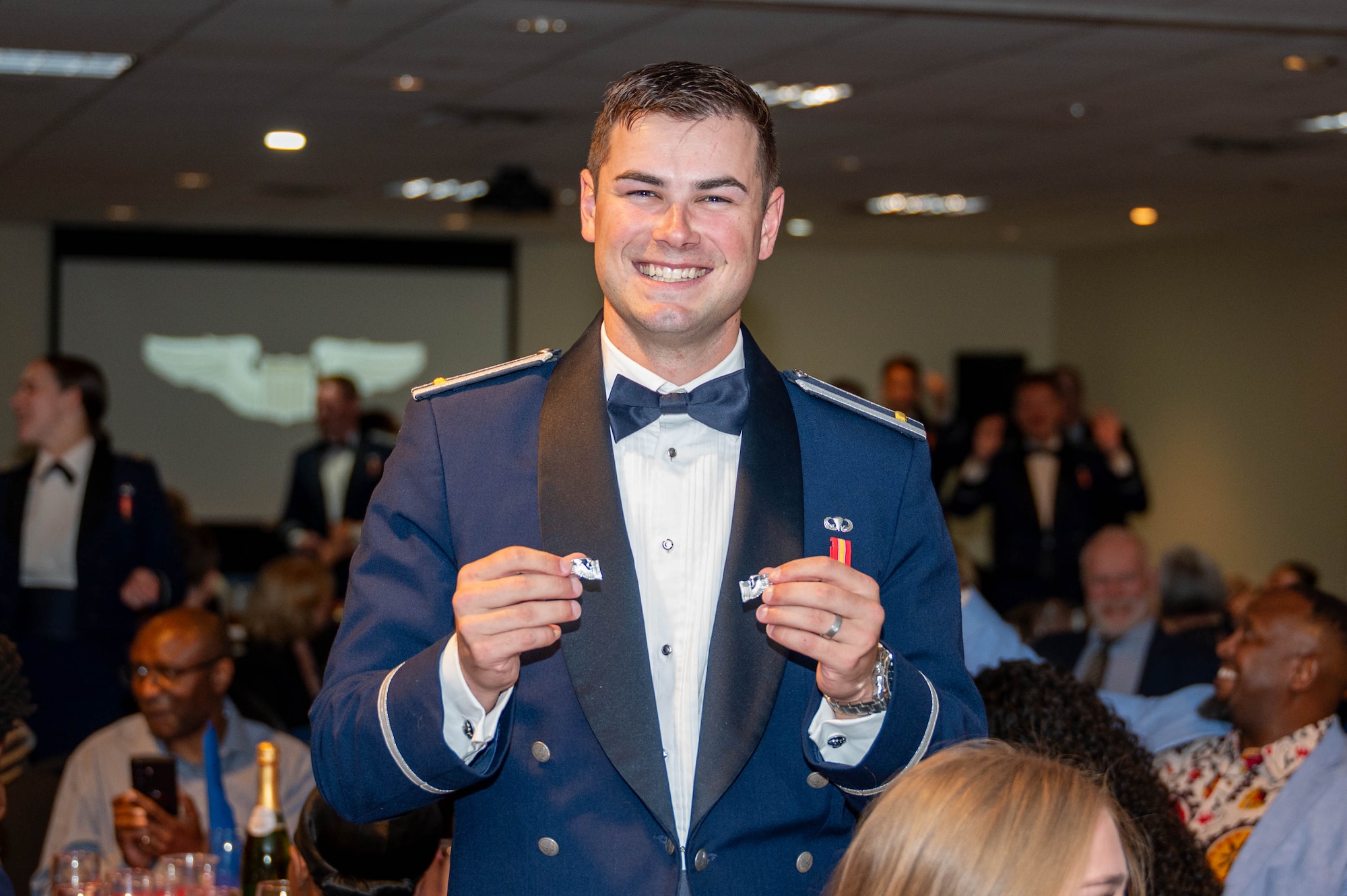 2nd Lt. Dylan Rogers, 47th Student Squadron student pilot, holds up his broken silver wings.