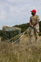 U.S. Army Sgt. Keith Courtney, a parachute rigger assigned to the 173rd Brigade Support Battalion, 173rd Airborne Brigade, recovers a parachute during exercise Saber Junction 26 at the Joint Multinational Readiness Center's Hohenfels Training Area, Germany, Aug. 24, 2026. Saber Junction 26 is an annual exercise for U.S. Army Europe and Africa's permanently assigned brigades and participating Allies and partners. (U.S. Army photo by Sgt. 1st Class Seth Plagenza)