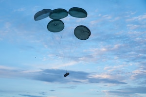 A military transport aircraft drops supplies during exercise Saber Junction 26 at  the Joint Multinational Readiness Center's Hohenfels Training Area, Germany, Aug 24, 2026. The Continuous Transformation Initiative is grounded in one principle: increasing the lethality of U.S. Army formations by creating more agile and mobile units capable of responding to complex combat scenarios. (U.S. Army photo by Pfc. William Justus)