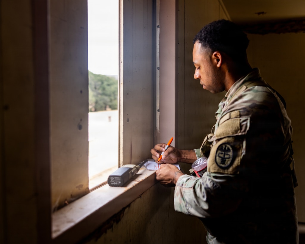 U.S. Army Sgt. Ahmad Cole, a veterinary food inspection specialist with Veterinary Readiness Activity – San Diego, documents an enemy Size, Activity, Location, Unit, Time, Equipment report during a field training exercise at Marine Corps Base Camp Pendleton, California, Aug. 13, 2026. The training exercise was designed to increase technical knowledge, acclimate personnel to austere combat environments and refine fundamental skills such as close-quarters battle and Tactical Combat Casualty Care. (U.S. Marine Corps photo by Lance Cpl. Jonathan Sherchand).