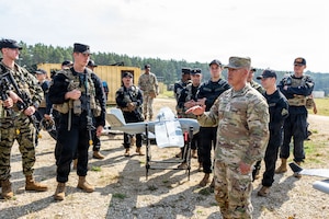 U.S. Army Brig. Gen. Terry R. Tillis, commanding general of 7th Army Training Command, speaks with Soldiers assigned to Joint Multinational Readiness Center's 1st Battalion, 4th Infantry Regiment, during Saber Junction 26 at the Joint Multinational Readiness Center’s Hohenfels Training Area, Germany, Aug. 26, 2026. 7th Army Training Command provides a unique environment in Europe to develop leaders and formations who are prepared for large-scale combat operations, improving readiness. (U.S. Army photo by Sgt. Collin Mackall)