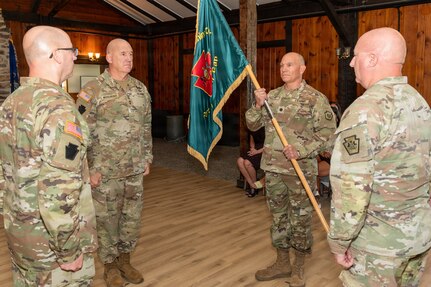 U.S. Army Maj. Gen. Michael E. Wegscheider, Pennsylvania National Guard Deputy Adjutant General-Army, passes the organizational colors to U.S. Army National Guard Lt. Col. Robert M. Cuthie during a change-of-command ceremony at Fort Indiantown Gap, Pennsylvania, Aug. 29. Cuthie assumed command of the Fort Indiantown Gap National Guard Training Center from U.S. Army National Guard Col. Kevin D. Potts during the ceremony. (Pennsylvania National Guard photo by Wayne V. Hall)