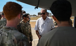 U.S. Airmen assigned to the 100th Aircraft Maintenance Squadron ask questions during a wireless communications demonstration on a KC-135 Stratotanker at RAF Mildenhall, England, Aug. 14, 2026.