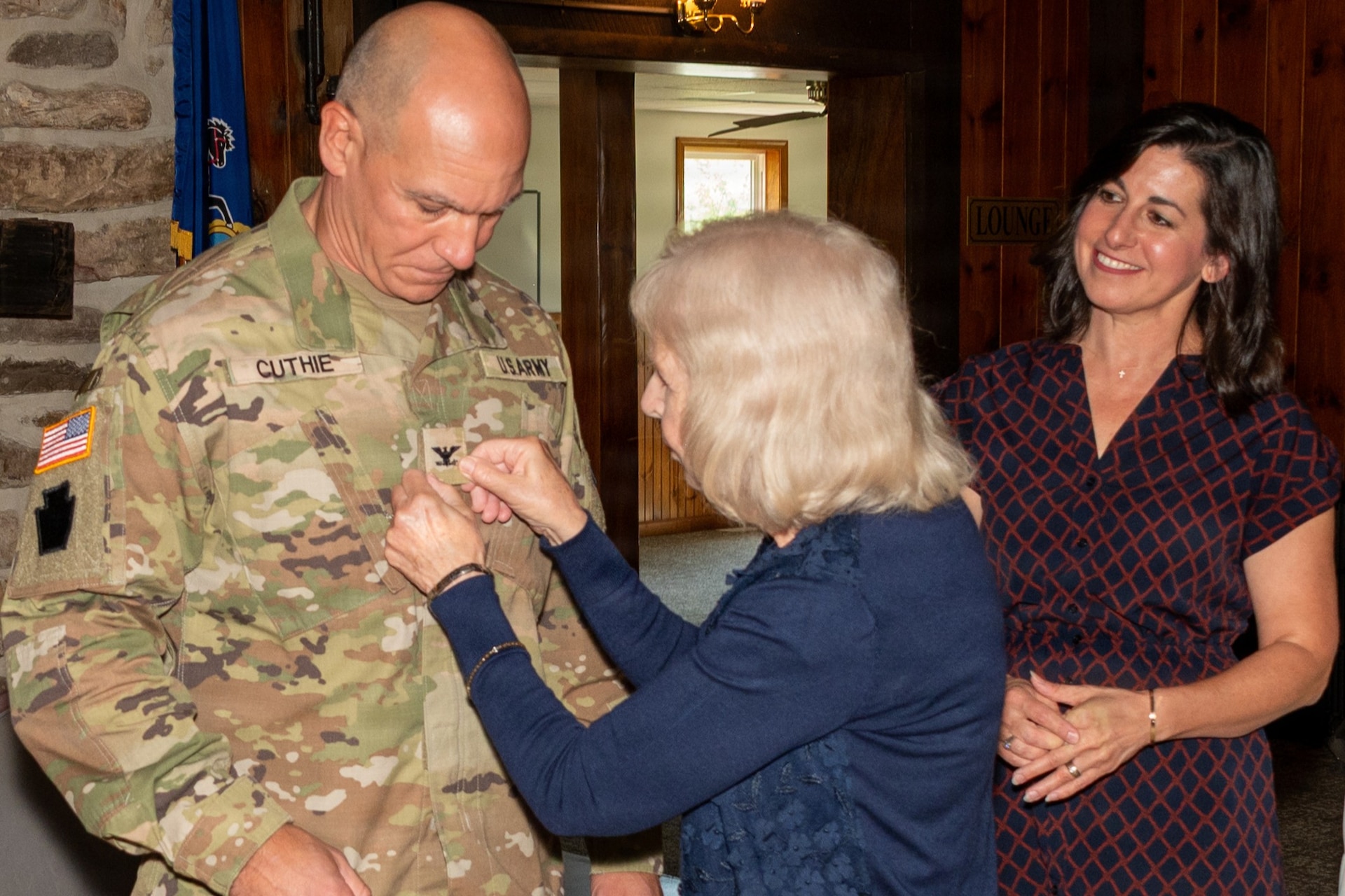 Family members pin the rank insignia of colonel onto Col. Robert M. Cuthie during a promotion ceremony at Fort Indiantown Gap, Pennsylvania, Aug. 29. The promotion ceremony was held immediately following a change-of-command ceremony where Cuthie assumed command of the Fort Indiantown Gap National Guard Training Center.