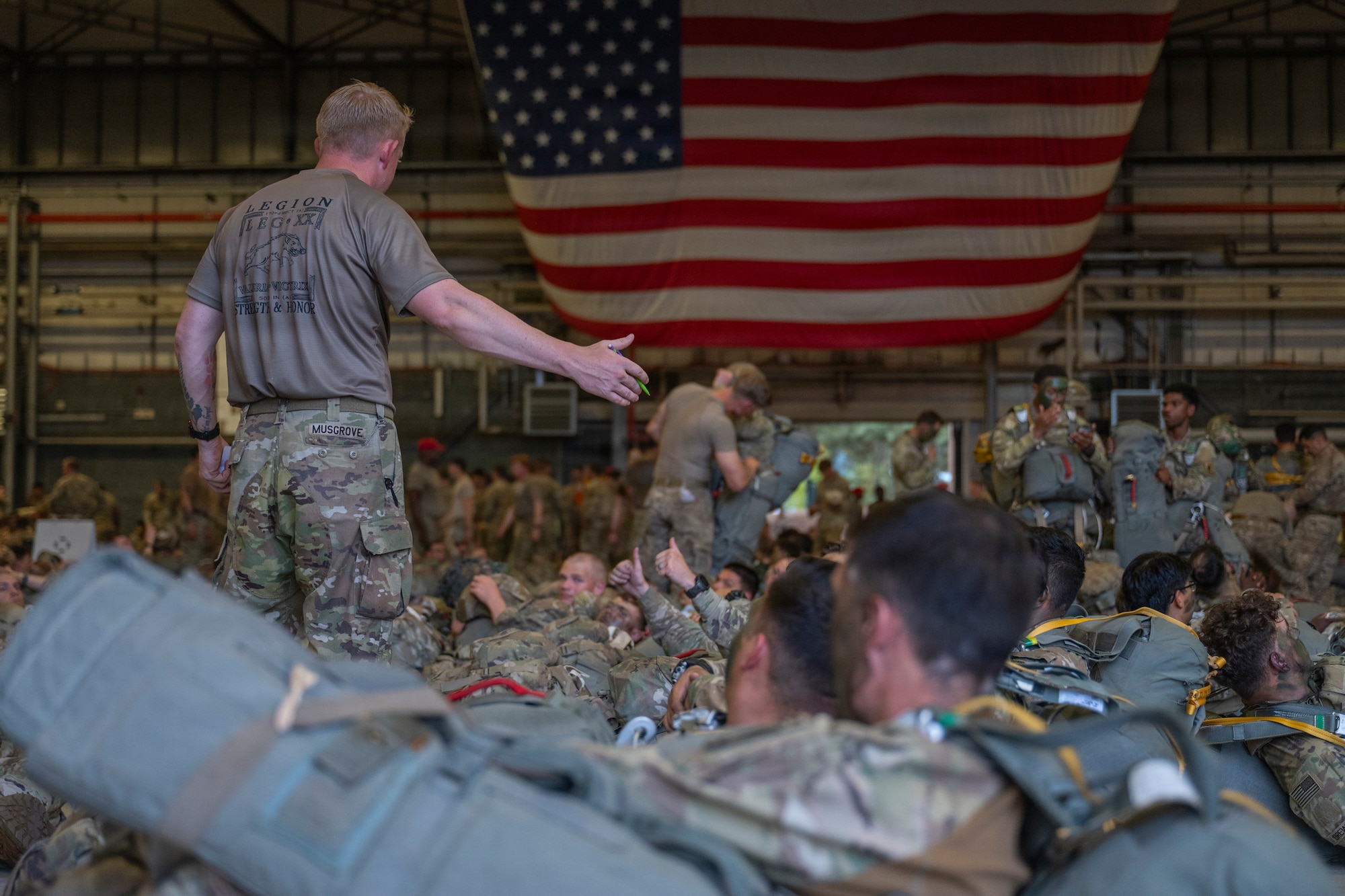 A U.S. Soldier instructs paratroopers preparing for a joint forcible entry operation during exercise Saber Junction 26 at Ramstein Air Base, Germany, Aug. 26, 2026.