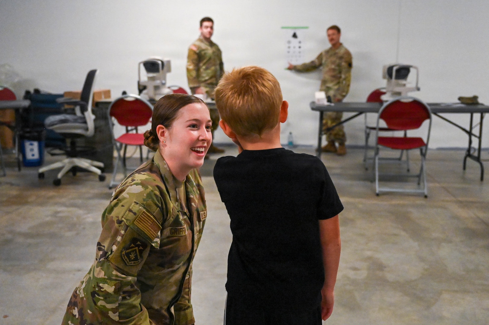 An Airman assigned to the 179th Medical Group performs a vision examination on a young patient during GuardCare 2026 at the Ohio University Heritage College of Osteopathic Medicine’s Heritage Hall in Athens, Ohio, Aug. 1, 2026.