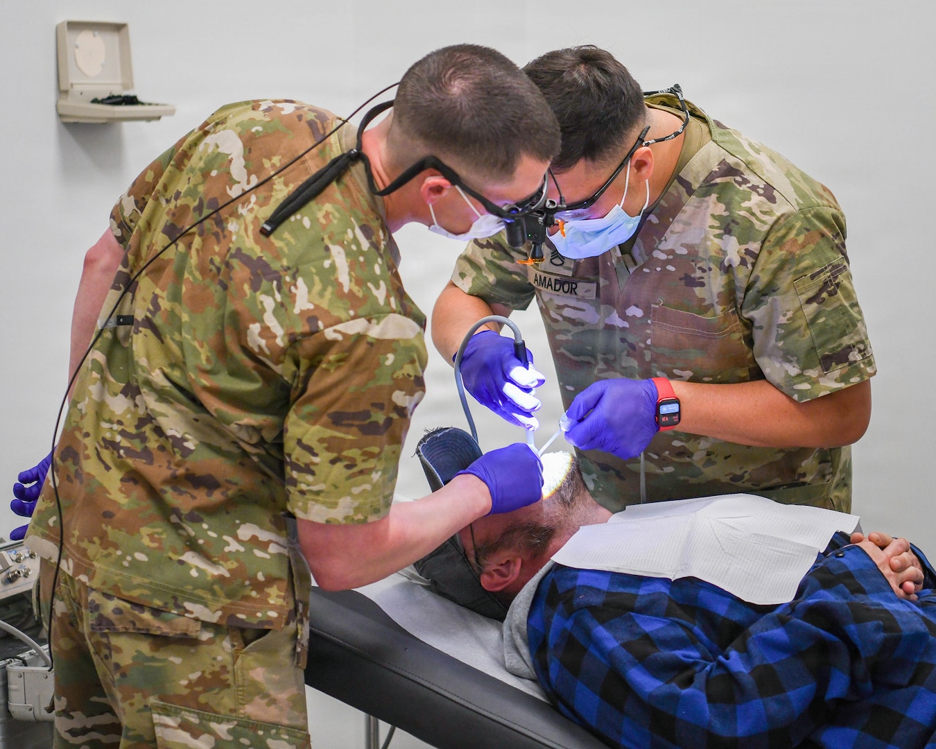 Two Soldiers assigned to the Ohio Army National Guard’s 684th Medical Company, perform dental care on a patient during GuardCare 2026 at the Ohio University Heritage College of Osteopathic Medicine’s Heritage Hall in Athens, Ohio, Aug. 1, 2026.