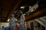 U.S. Air Force Maj. Gen. Travolis Simmons, 19th Air Force commander, left, observes as TSgt Jose Sanchez, 336th Training Support Squadron vehicle maintenance noncommissioned officer in charge, demonstrates vehicle maintenance needs during his visit to the 336th Training Group’s survival, evasion, resistance, and escape schoolhouse at Fairchild Air Force Base, Wash., Aug. 24, 2026. The 19th Air Force leadership observed firsthand the day-to-day operations that go into the SERE mission of ensuring service members are equipped with the necessary skills to return with honor. (U.S. Air Force photo by Senior Airman Stephanie Orta Carranza)