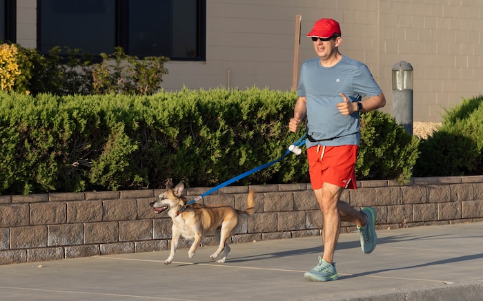 Col. David Aparicio, 412th Electronic Warfare Group commander, starts his day by running with his dog, Hunter, to decompress, clear his mind and stay physically active while sparking fresh ideas, Edwards Air Force Base, California, Aug. 28. (U.S. Air Force photo by Lindsey Gordon)