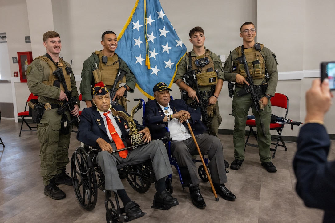 U.S. Marines pose for a photo with retired U.S. Marine Corps Gunnery Sgt. Francis M. Hooper Jr., bottom left, with the Montford Point Marine Association, and retired U.S. Marine Maj. James C. Capers Jr., medal of honor recipient, concluding the 17th Annual Montford Point Marine Day Ceremony on Camp Gilbert H. Johnson, North Carolina, Aug. 28, 2026. Marine Corps Installations East-Marine Corps Base Camp Lejeune is dedicated to honoring the legacy of the first African American men who enlisted and trained in the United States Marine Corps from 1942 to 1949 by hosting this annual event. (U.S. Marine Corps photo by Cpl. Jessica J. Mazzamuto)