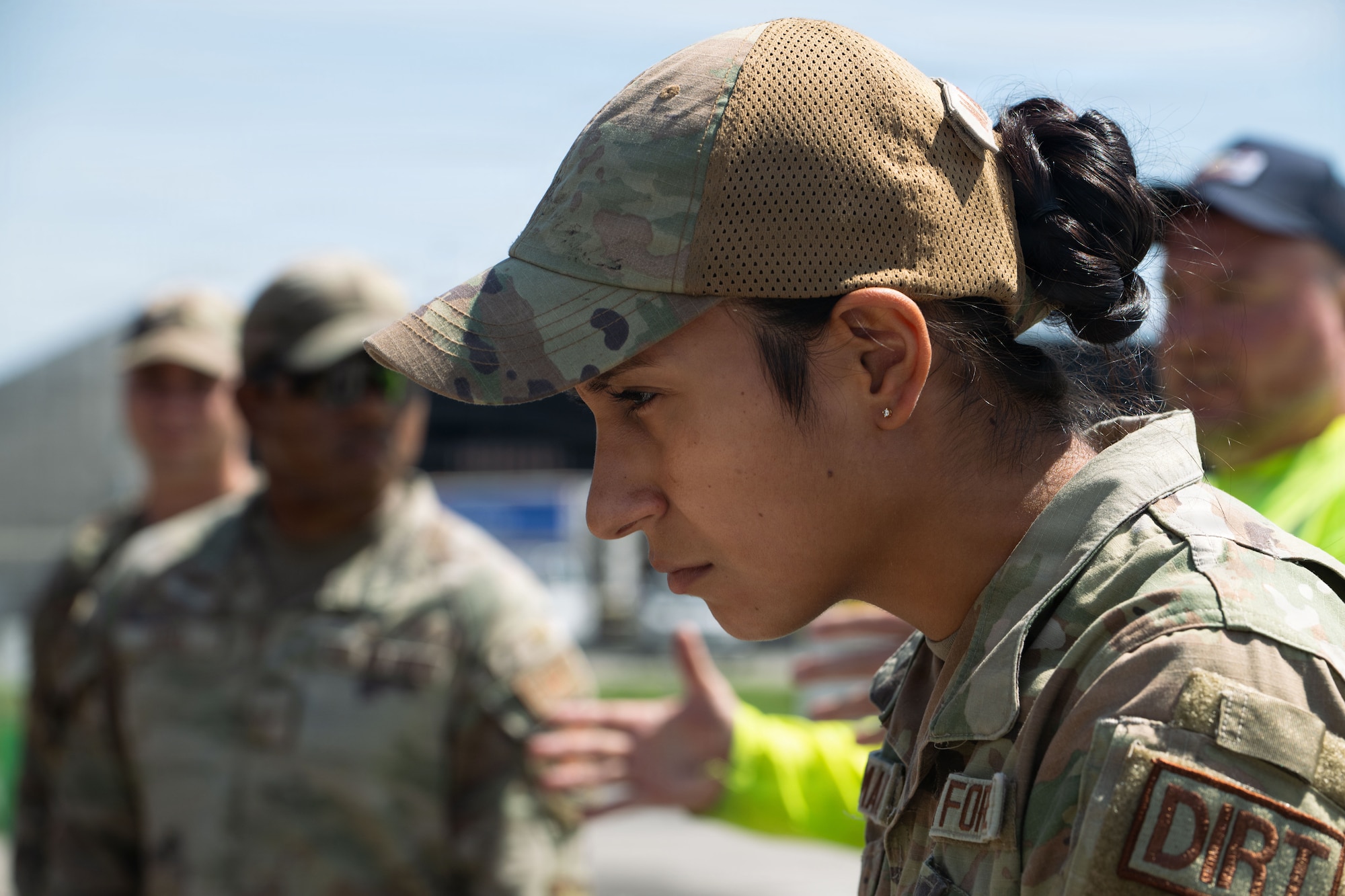 A female airmen looks at something.