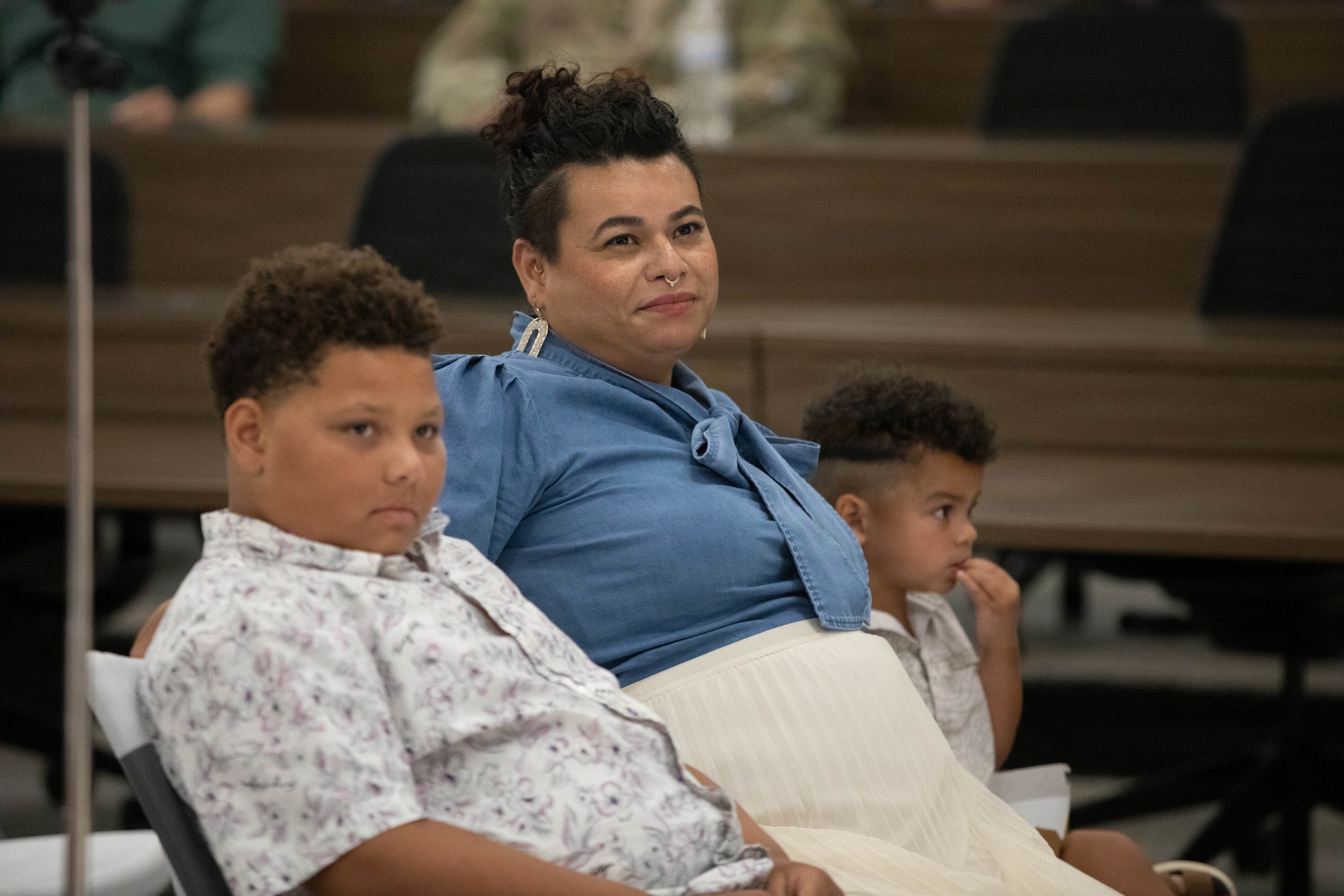U.S. Army Sgt. Maj. Michael Meredith's wife, Maritza, and two sons, Brayden and Jameson, look on as he is promoted during a ceremony at Barker Auditorium at Boone National Guard Center in Frankfort, Kentucky, Aug. 10.