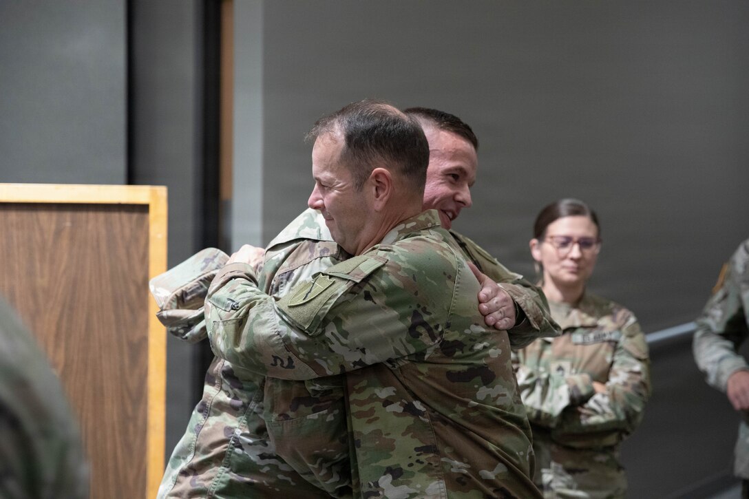 U.S. Army Sgt. Maj. Michael Meredith is congratulated by Command Sgt. Maj. Jesse Withers following a promotion ceremony at the Barker Auditorium at Boone National Guard Center in Frankfort, Kentucky, Aug. 10.
