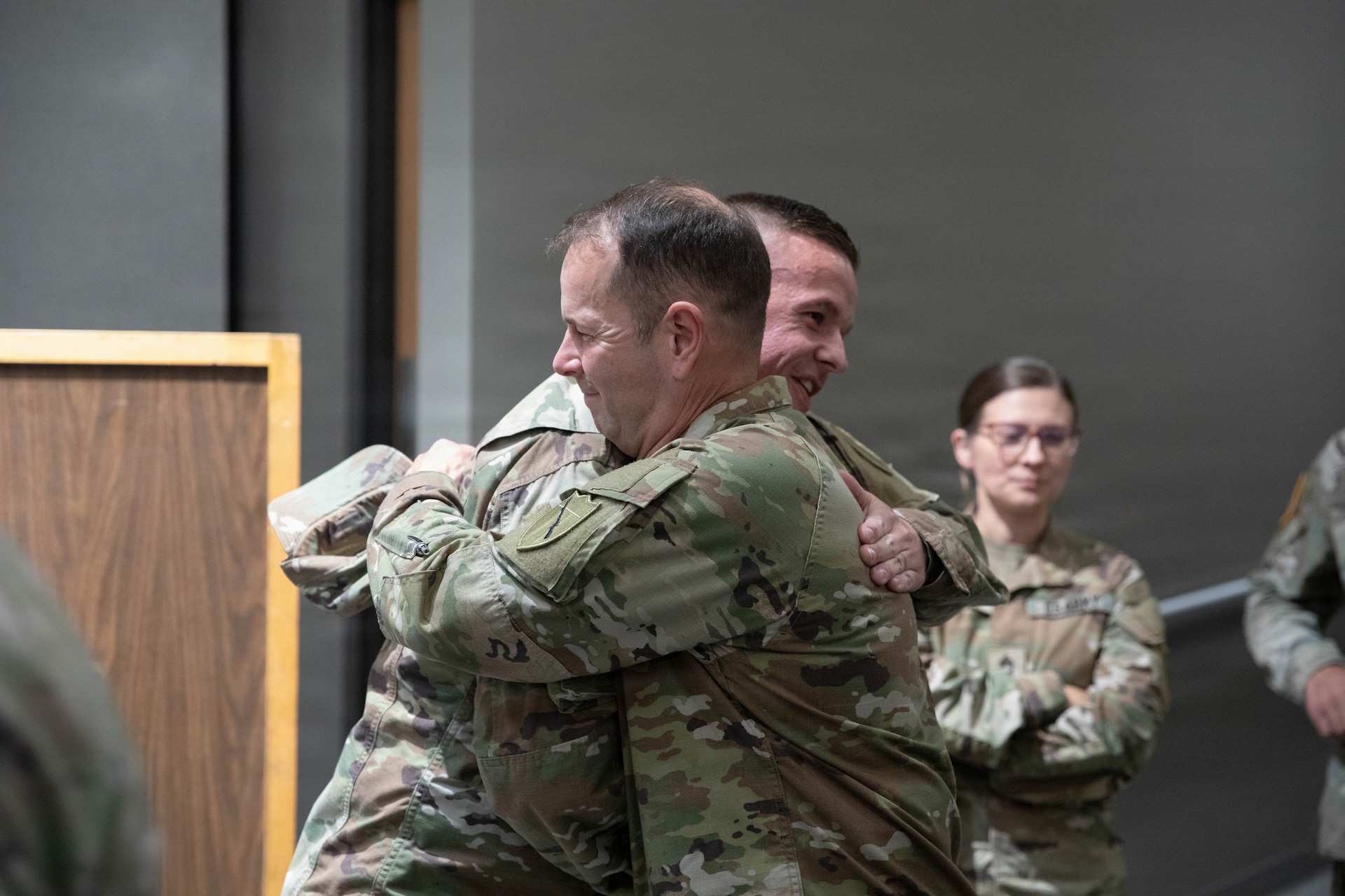 U.S. Army Sgt. Maj. Michael Meredith is congratulated by Command Sgt. Maj. Jesse Withers following a promotion ceremony at the Barker Auditorium at Boone National Guard Center in Frankfort, Kentucky, Aug. 10.