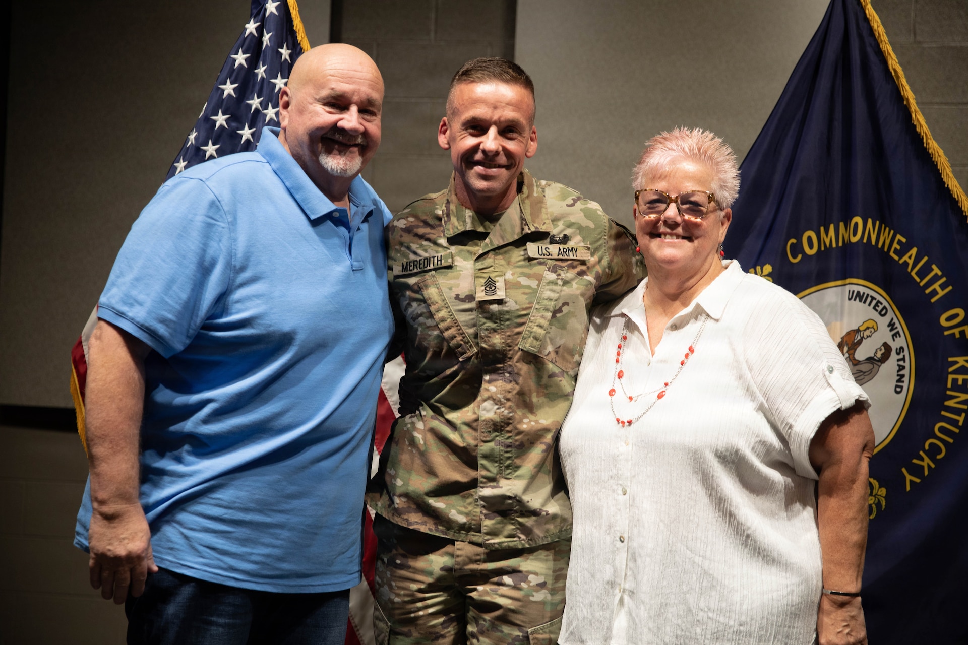 U.S. Army Sgt. Maj. Michael Meredith with his parents, Mark and Diane Meredith, following a promotion ceremony at the Barker Auditorium at Boone National Guard Center in Frankfort, Kentucky, Aug. 10.