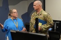 U.S. Airman listens to a civilian talking