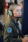 uniformed USAF Airmen fly MQ-9 simulators