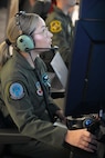 uniformed USAF Airmen fly MQ-9 simulators