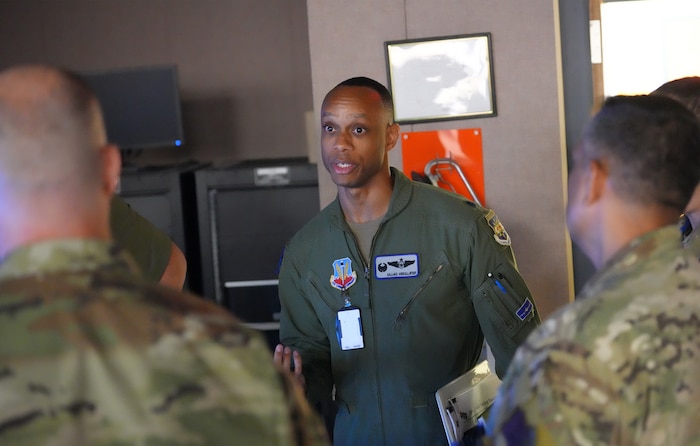uniformed USAF member briefs other Airmen