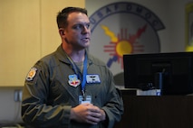 uniformed USAF member briefs other Airmen