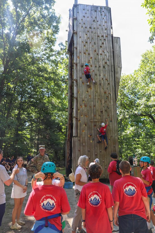 A camper climbs the confidence climbing wall as other campers and Kentucky Guard Senior Leaders look on during the annual Youth Camp at Camp Loucon in Leitchfield, Kentucky, July 16, 2026.