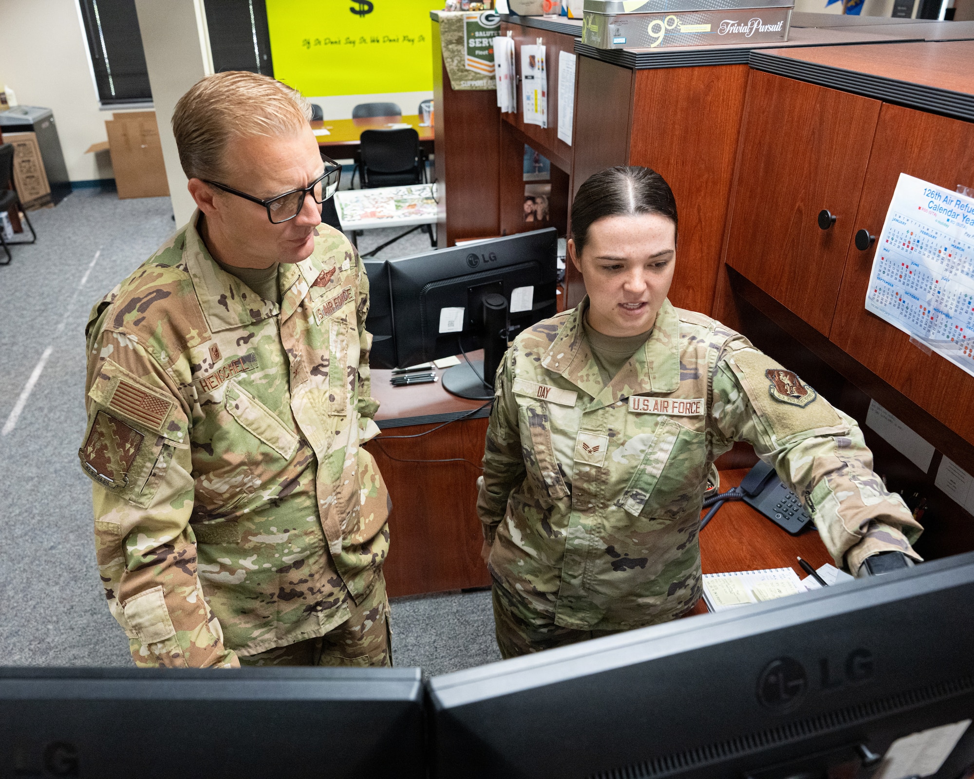 Airman points to screen.