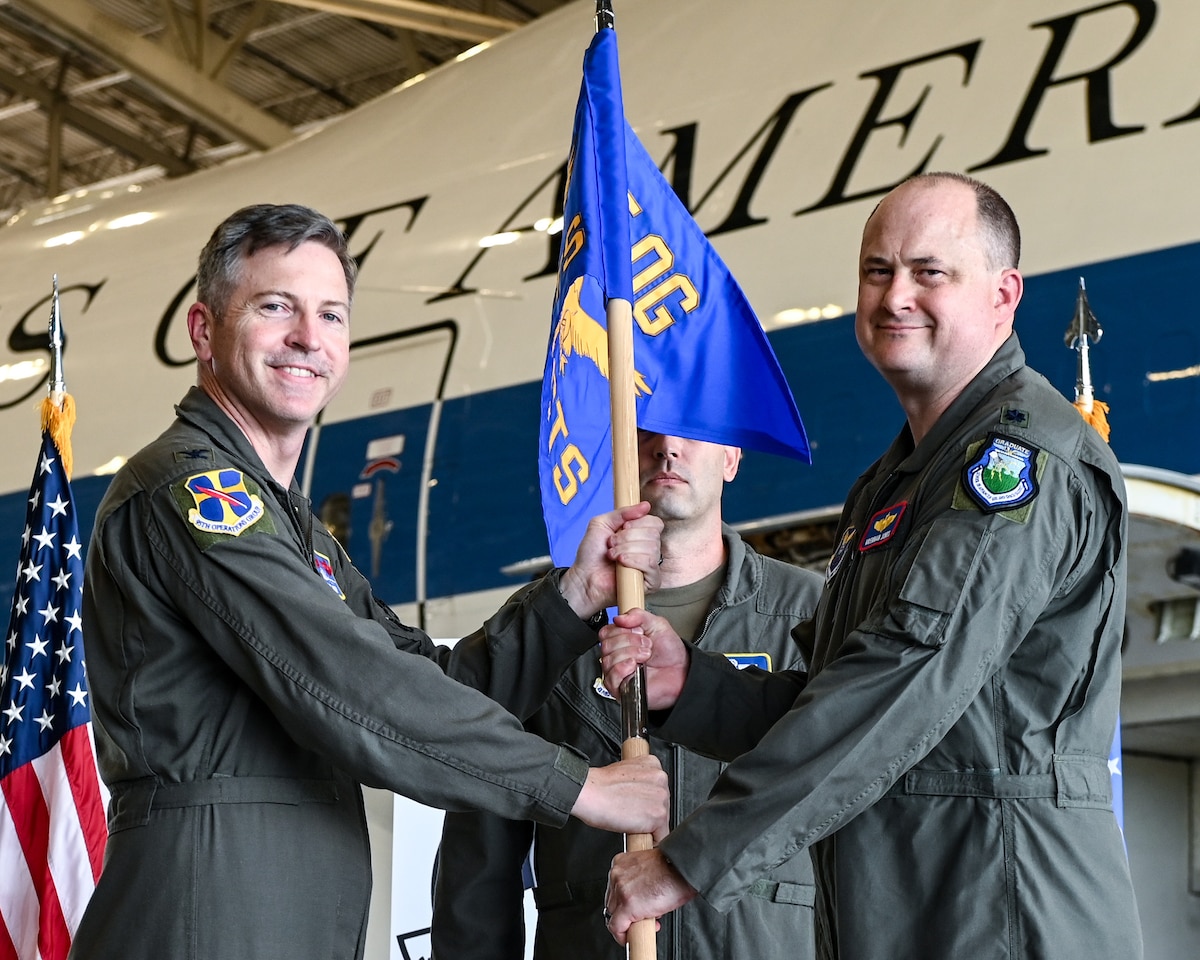 U.S. Air Force Col. Patrick Hook, left, 95th Operations Group commander, and Lt. Col. Brennan Jones, incoming 334th Combat Training Squadron commander, hold the guidon during the 334th CTS activation ceremony on Offutt Air Force Base, Nebraska, Aug. 28, 2026.